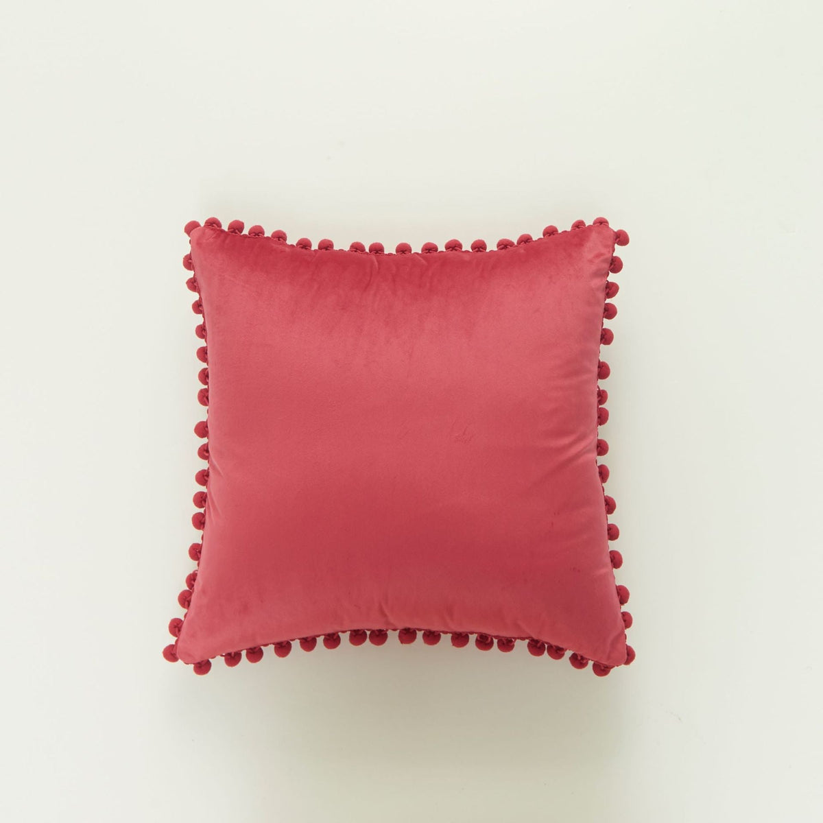 Coussin décoratif en velours à pompons