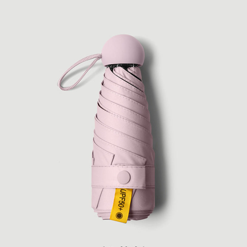 Parapluie de poche forme capsule avec protection solaire UPF50