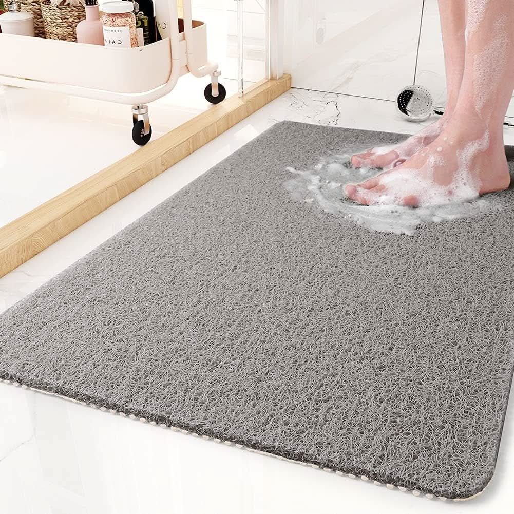 Tapis de douche antidérapant avec système d'évacuation